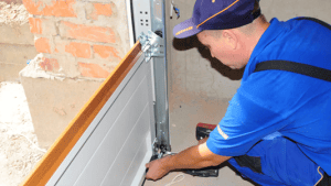 Garage door service visit – A technician working on a garage door