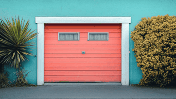 Coastal garage door - Pink garage door with a blue wall