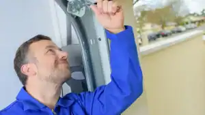 Technician performing a garage door inspection
